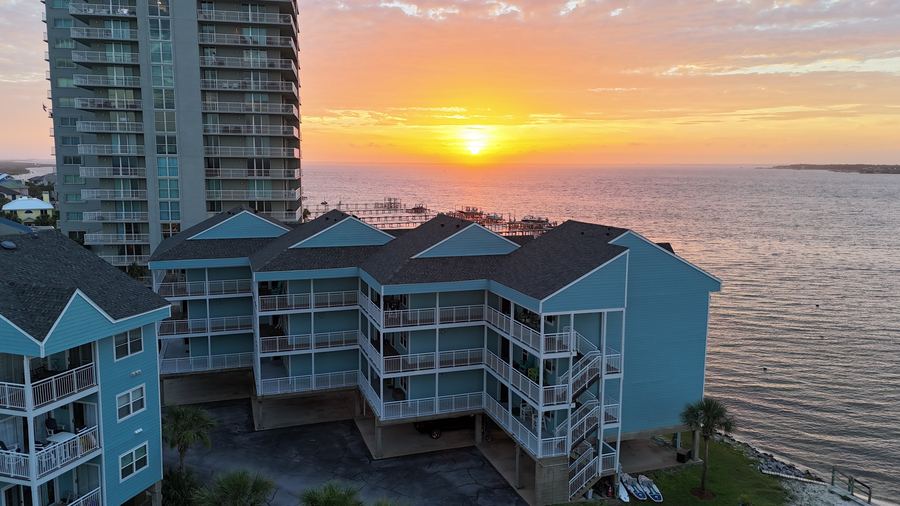 Drone shot overlooking the water and piers at golden hour