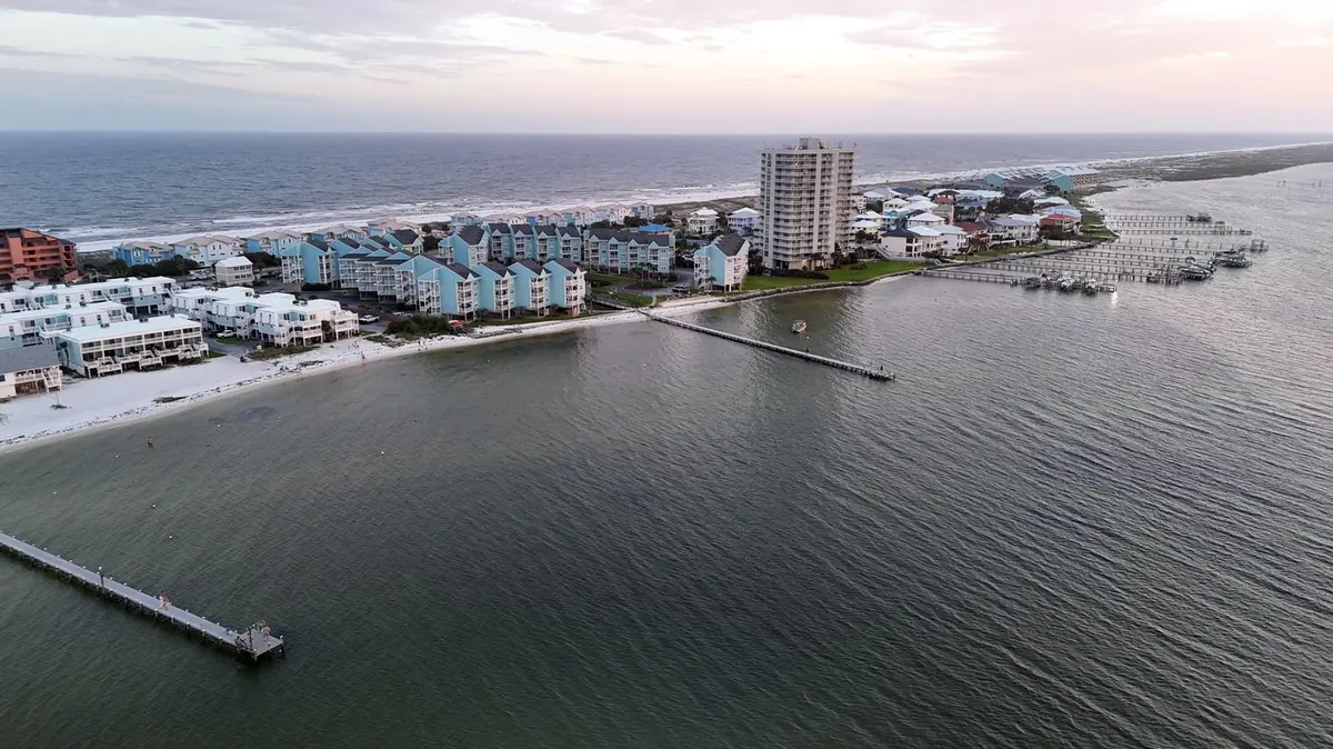Aerial sunset view of private docks and boats on the bay