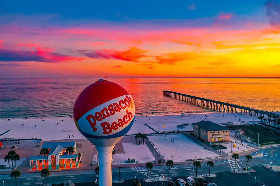 Iconic Pensacola Beach ball landmark at sunset with the pier beyond