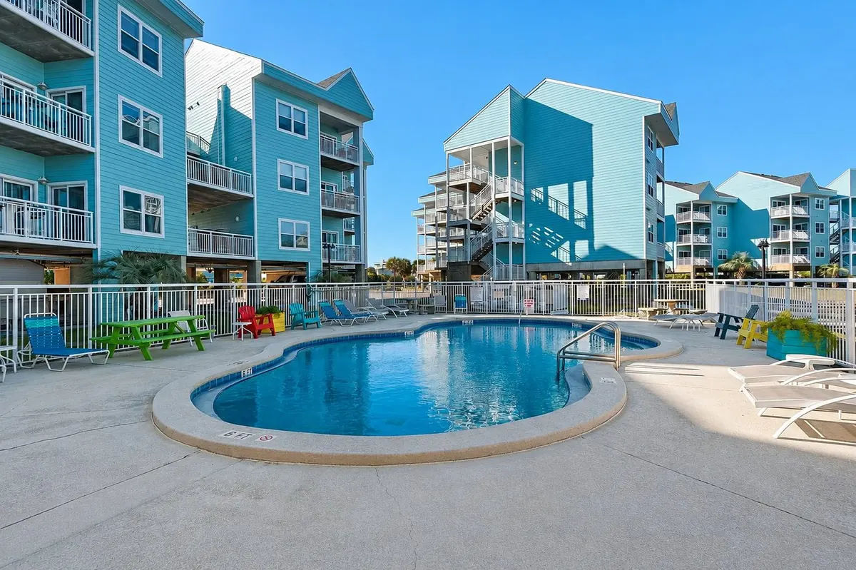 Community pool with lounge seating overlooking the bay